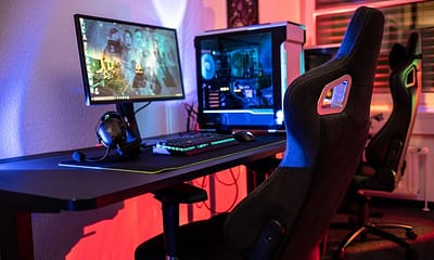 a desk with a computer and a gaming chair